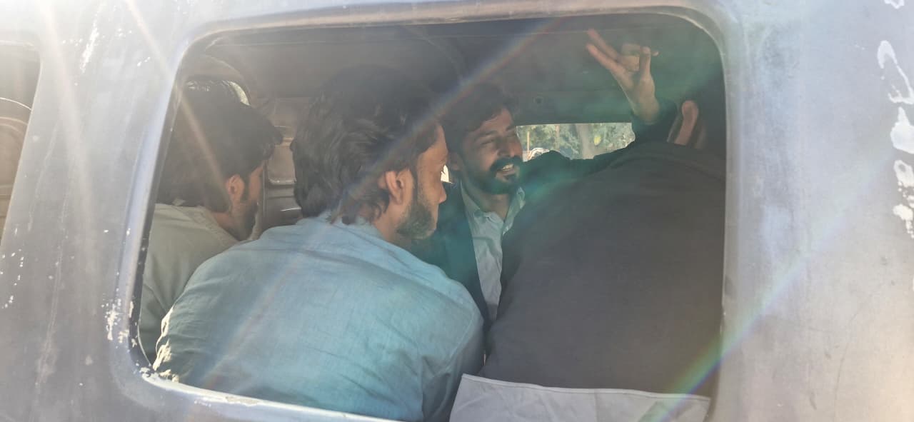 Photo of Iqbal Abro taken through a car window